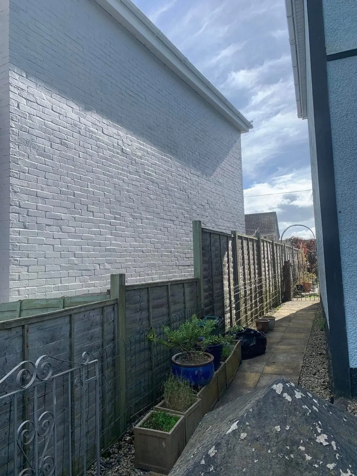 Freshly painted brick wall after preparation and masonry paint in St Ives